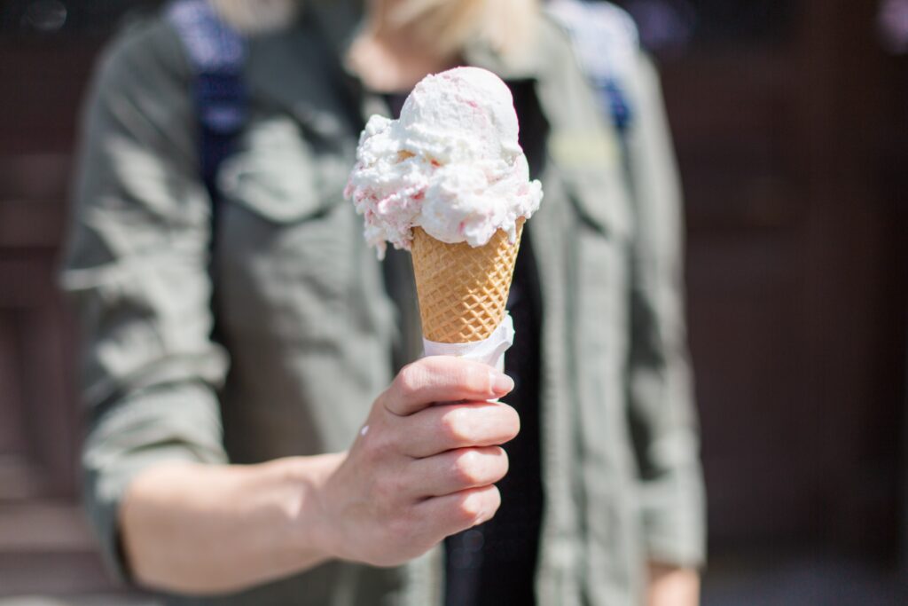 woman holding an ice cream cone on a sunny day