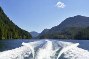 wake of a speedboat on the surface of a lake in the summertime