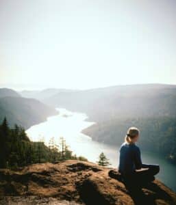 woman sitting at a peak with a view of the Saanich Inlet - Victoria BC