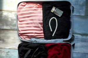 packing-suitcase-at-home-with-woman-items-accesso-2025-10-13-00-33-09-utc