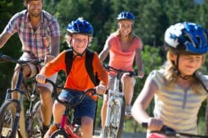 chilren and parents riding bikes on a sunny day - family activities
